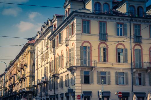 Old style buildings with balconies, windows and shutters in historical city centre of Turin Torino city, vintage photo, Piedmont, Italy