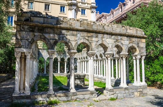 Ruins of Chiostro di Sant'Andrea monastery with columns and green plants around in historical centre of old european city Genoa Genova, Liguria, Italy