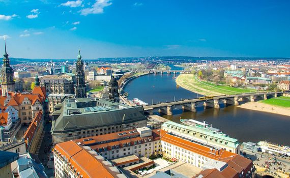 Panoramic view of Dresden city with bridges over Elbe river and old buildings from view platform of lutheran church of Our Lady Frauenkirche, Germany