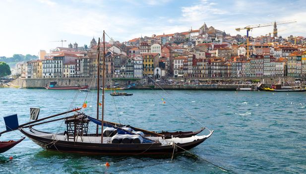 View of Old Porto, Oporto city, colorful Ribeira traditional wine boats in Douro river from Vila Nova de Gaia, Portugal