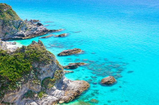 Rock and cliff of cape Capo Vaticano Ricadi aerial panoramic view from Parco Belvedere platform of green rock hill with amazing blue azure turquoise water of Tyrrhenian sea, Calabria, Southern Italy