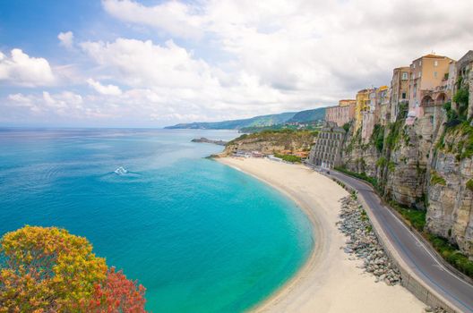 Tropea town and Tyrrhenian Sea beach, colorful buildings on top of high big steep rock cliff, view from Sanctuary church of Santa Maria dell Isola, Vibo Valentia, Calabria, Southern Italy