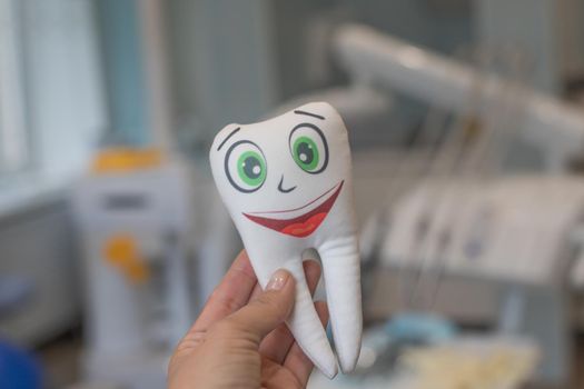 Smiling tooth.Dental explorer probe with healthy tooth model