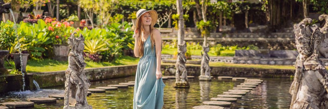 Young woman tourist in Taman Tirtagangga, Water palace, Water park, Bali Indonesia. BANNER, LONG FORMAT