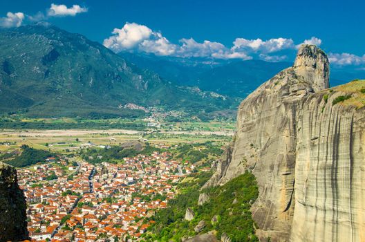 View of mountains and valley near town of Kalabaka from the top of rock Holy Trinity Monastery of Meteora Monasteries, Greece