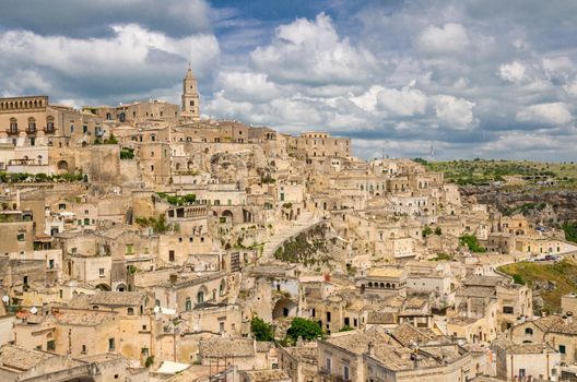 Matera panoramic view of historical centre Sasso Caveoso Sassi old ancient town with rock houses with blue sky white clouds, European Culture Capital, UNESCO World Heritage, Basilicata, Southern Italy
