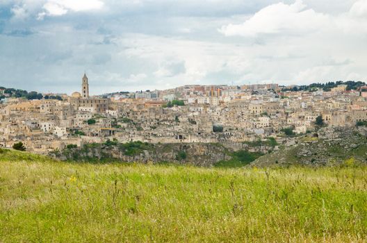 Matera panoramic view of historical centre Sasso Caveoso old ancient town Sassi di Matera with cave rock houses with dramatic sky, view from Murgia Timone, UNESCO Heritage, Basilicata, Southern Italy