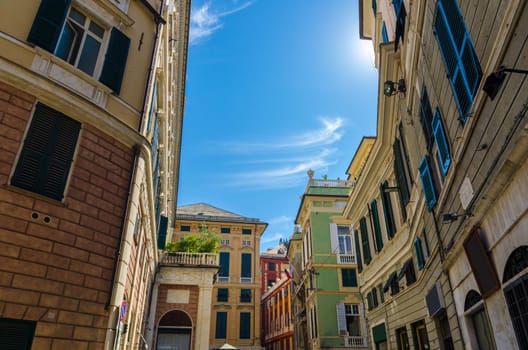 Piazza della Meridiana square with multicolored typical traditional buildings with colorful walls, windows with shutters in historical centre of old european city Genoa Genova , Liguria, Italy