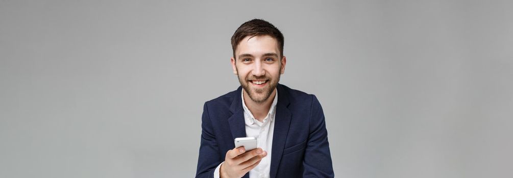 Business Concept - Portrait handsome happy handsome business man in suit playing moblie phone and smiling with laptop at work office. White Background.