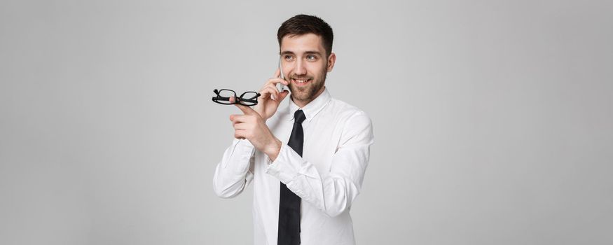 Lifestyle and Business Concept - Portrait of a handsome businessman enjoy talking with mobile phone. Isolated White background. Copy Space.