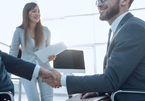 business handshake in an office. the concept of partnership.