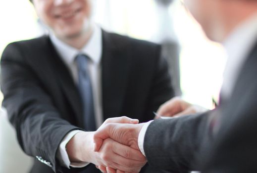background image close-up of handshake of business partners. the concept of partnership