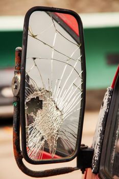 Cracked side mirror on an old truck. Broken truck mirror