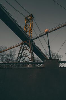 Landscape of a pedestrian bridge in the evening at sunset. Beautiful park landscape with photo filter