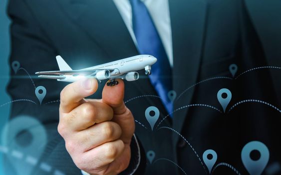 A plane taking off in the hands of a businessman and a pin location symbol. Business tourism. Organization of air traffic. Business class flights. Support financial program for civil aviation