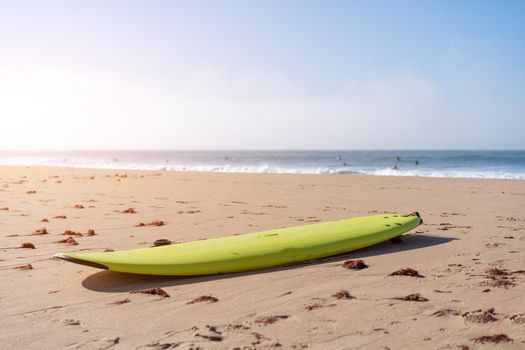 Serf board on the beach. View of nice Atlantic ocean beach with sand ,blue sea and blue sky. Holiday and vacation concept. Portugal Carcavelos