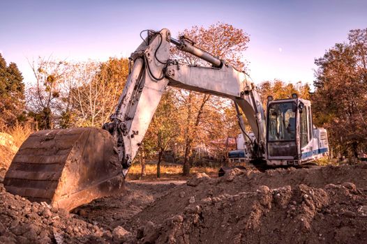 Rest, big excavator with shovel at construction site. Horizontal view