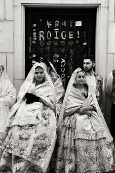 Elche, Alicante, Spain- December 29, 2019: People parading in procession dressing in regional costumes for the festivities of the Virgin of the Assumption in Elche