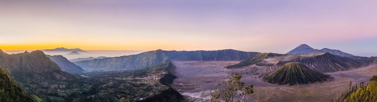 Sunrise at the Bromo Tengger Semeru National Park on the Java Island, Indonesia. View on the Bromo or Gunung Bromo on Indonesian, Semeru and other volcanoes located inside of the Sea of Sand within the Tengger Caldera. One of the most famous volcanic objects in the world. Travel to Indonesia concept.