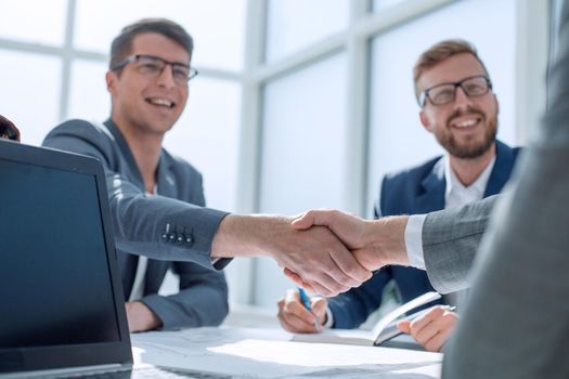 close up. business people shaking hands at a meeting in the office. concept of cooperation