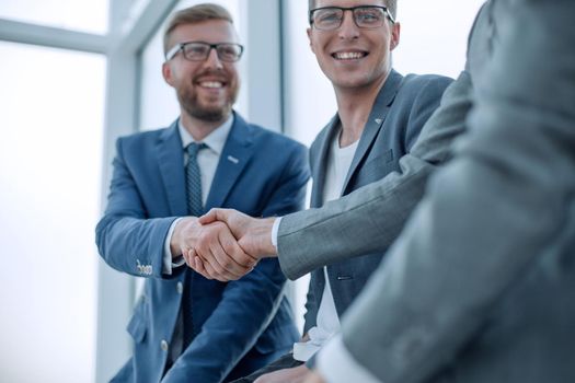 close up. smiling business colleagues shaking hands . business concept