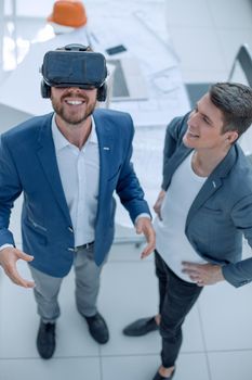 top view. smiling man looking through VR helmet. people and technology