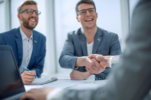 close up. business partners shaking hands at a meeting . concept of cooperation