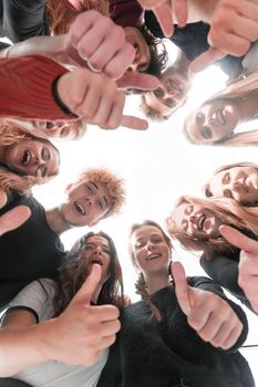 close up. group of happy young people standing in a circle