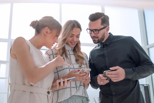 business team reading emails on their smartphones. people and technology