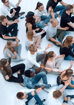 top view. a group of diverse young people meditate sitting on the floor