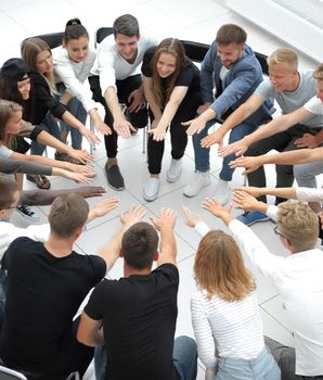 group of diverse young people putting their hands together. the concept of team building