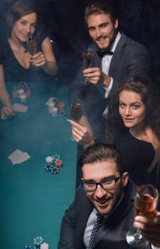 Group of young rich people is playing poker in the casino.photo with copy space