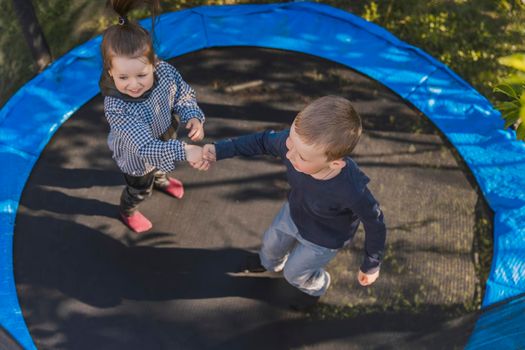 children jumping on a trampoline top view