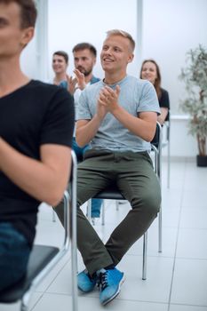 group of young people applaud at a group meeting. business and education