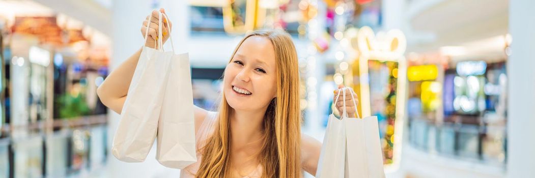 Young woman with purchases in new year shop. Christmas sale, black friday. BANNER, LONG FORMAT