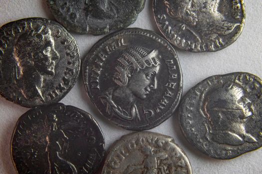 old roman coins on white background close up
