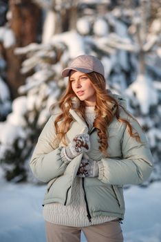 A model girl walking through a snow-covered forest