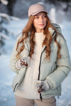 A model girl walking through a snow-covered forest