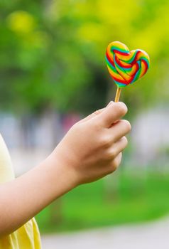 Lollipops in the hands of children. Selective focus. nature.