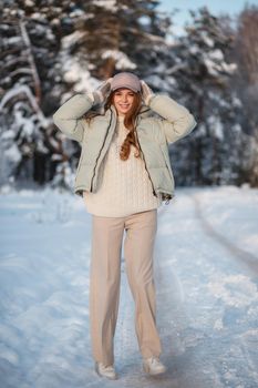 A model girl walking through a snow-covered forest