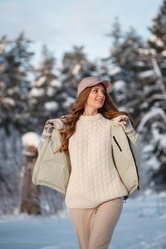 A model girl walking through a snow-covered forest