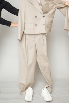 people keep a women's beige suit on the weight.