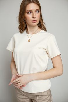 A model in brown casual clothes on a studio background.