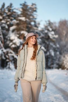 A model girl walking through a snow-covered forest