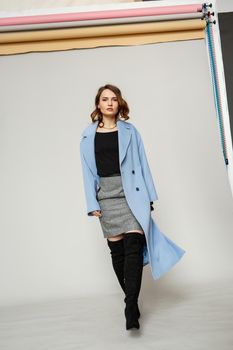 Beautiful brunette woman in a blue coat and nice top. Fashion spring autumn winter photo.