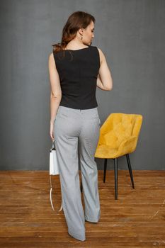 a model in a business suit on a studio background. Shooting fashionable clothes.