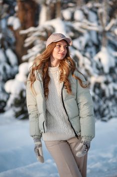 A model girl walking through a snow-covered forest