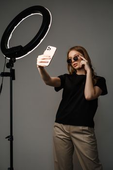 A model in casual clothes on a studio background. Shooting fashion clothes