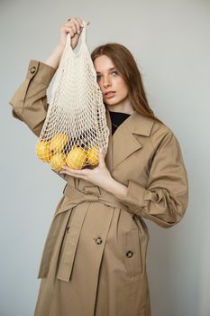 A model in a brown coat, a fashion demonstration.