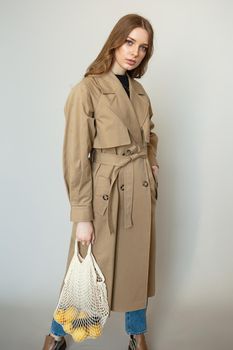 A model in a brown coat, a fashion demonstration.